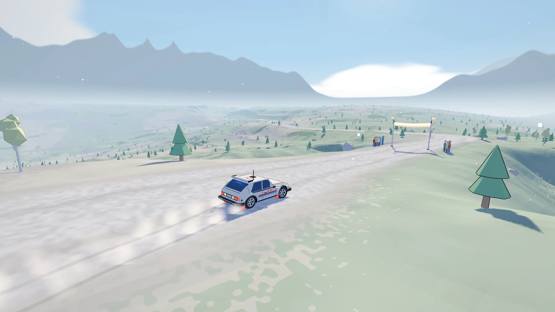 A white rally car on a pale snow-dusted road high above a green valley, blue-gray mountains behind and a gate banner in the distance.